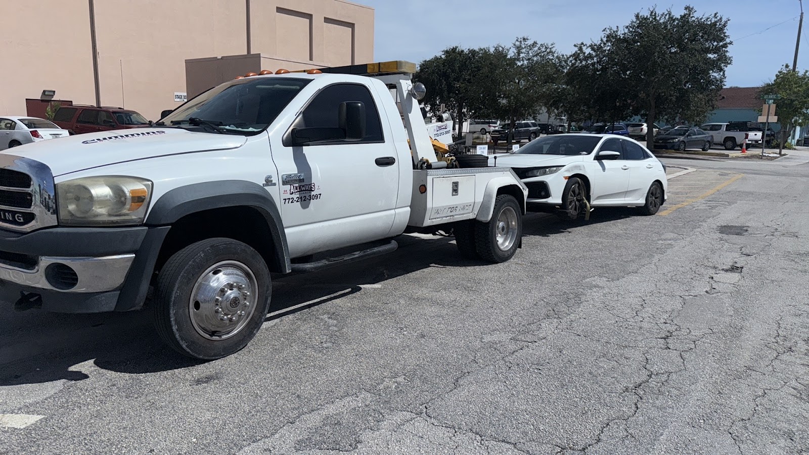AllWays Reliable Towing white tow truck with vehicle in tow Fort Pierce FL