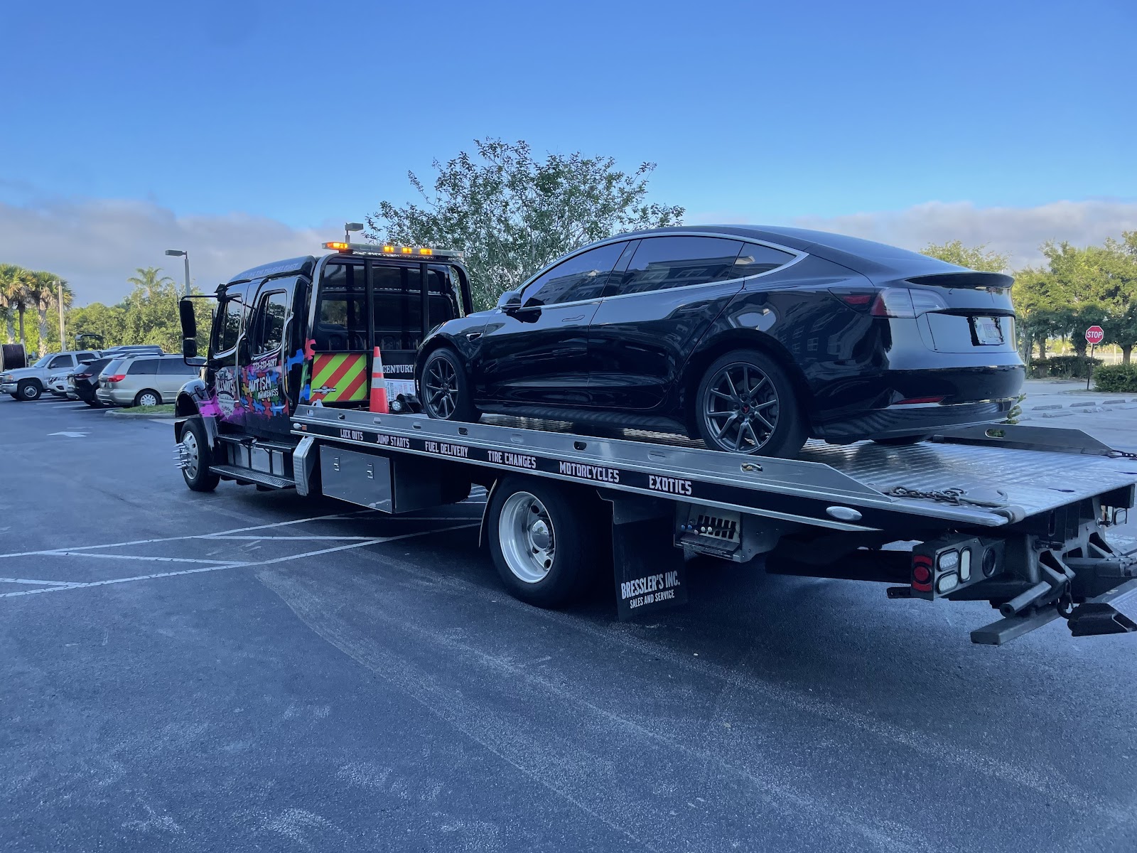 AllWays Reliable Towing branded rollback with black sedan Fort Pierce FL
